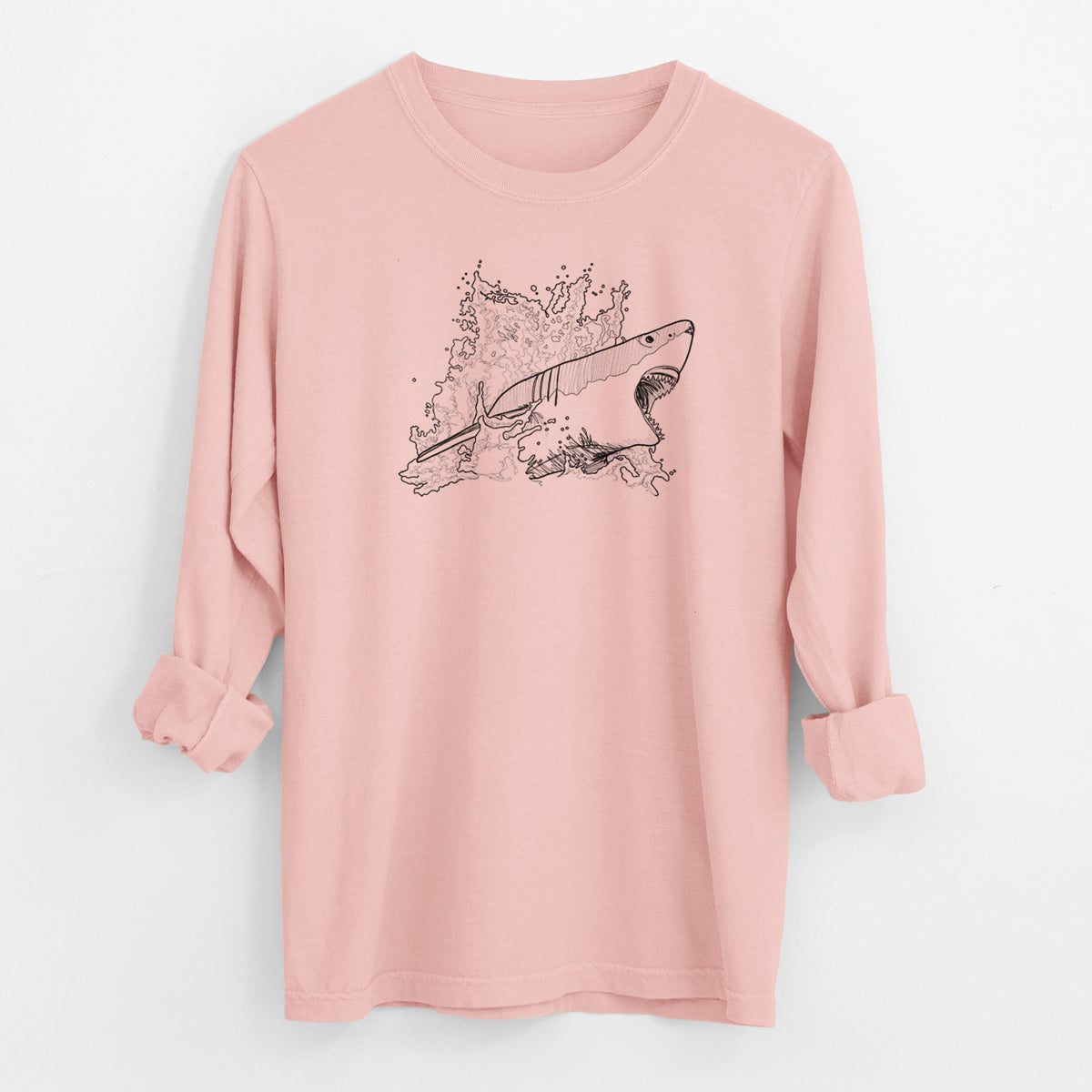 Peachy Comfort Colors long sleeve shirt laid flat with the cuffs rolled, printed with a black ink illustration of a great white shark breaking through a splash of water.
