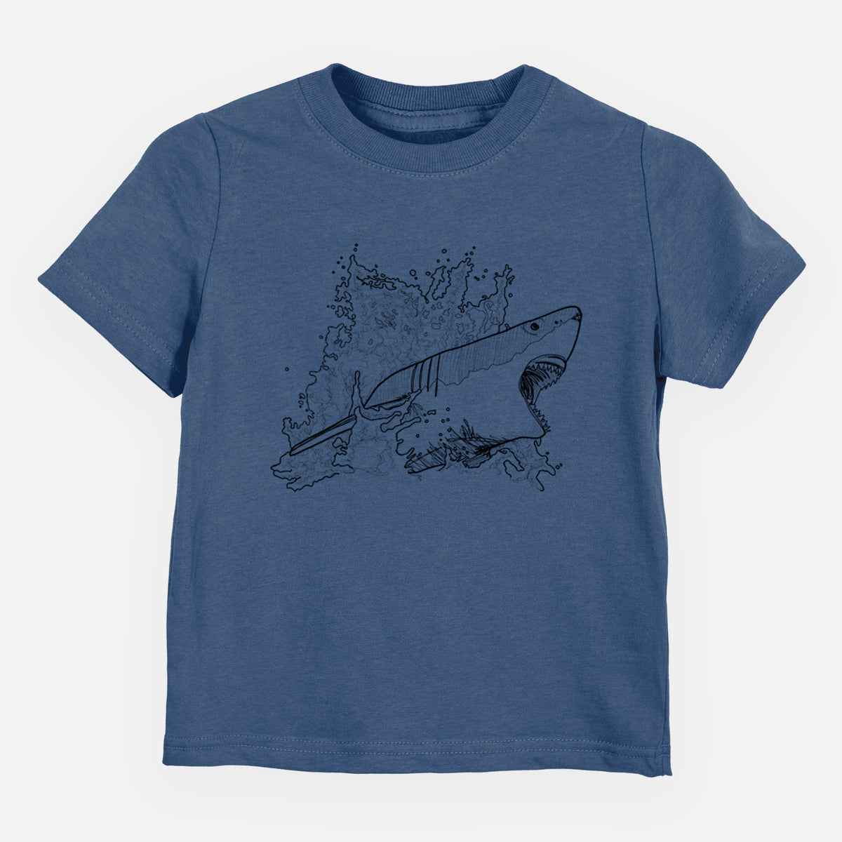 Indigo blue toddler t-shirt laid flat, printed with a black ink illustration of a great white shark breaking through a splash of water.