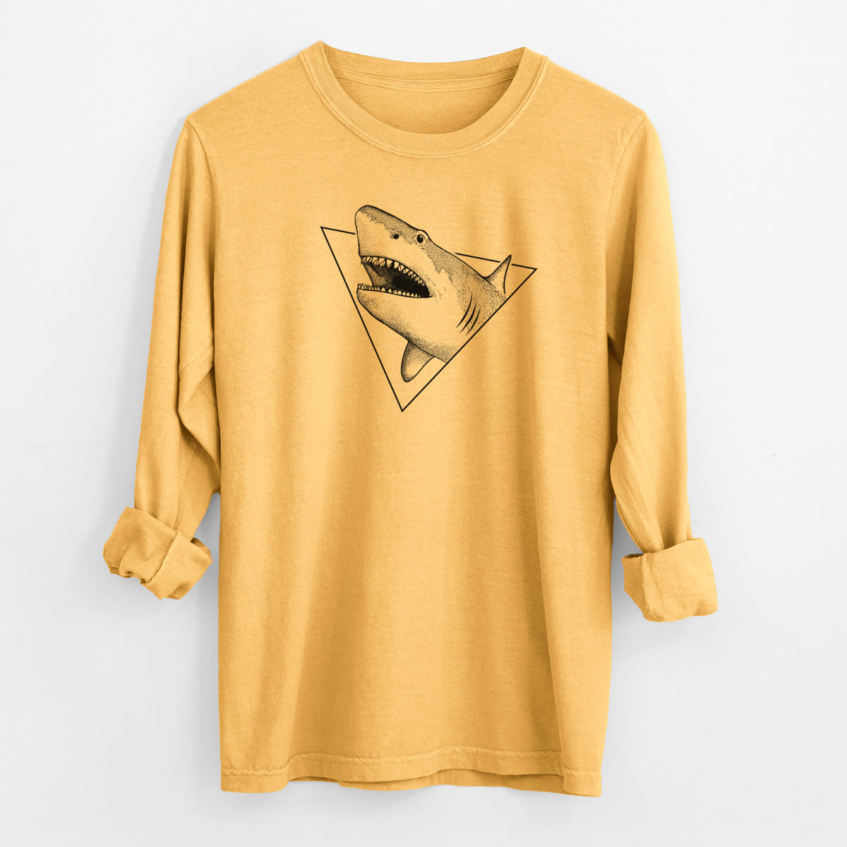 Golden wheat yellow Comfort Colors long sleeve shirt laid flat with the cuffs rolled, printed with a black ink great white shark bursting out of a triangle outline with its mouth open.