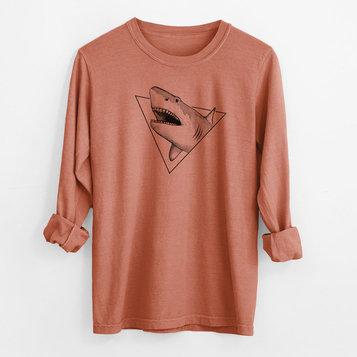 Yam burnt orange Comfort Colors long sleeve shirt laid flat with the cuffs rolled, printed with a black ink great white shark bursting out of a triangle outline with its mouth open.
