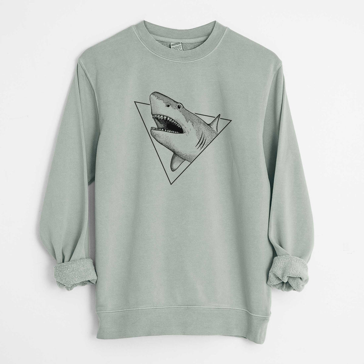 Sage green pigment dyed crewneck sweatshirt laid flat with the sleeves rolled, printed with a black ink great white shark bursting out of a triangle outline with its mouth open.