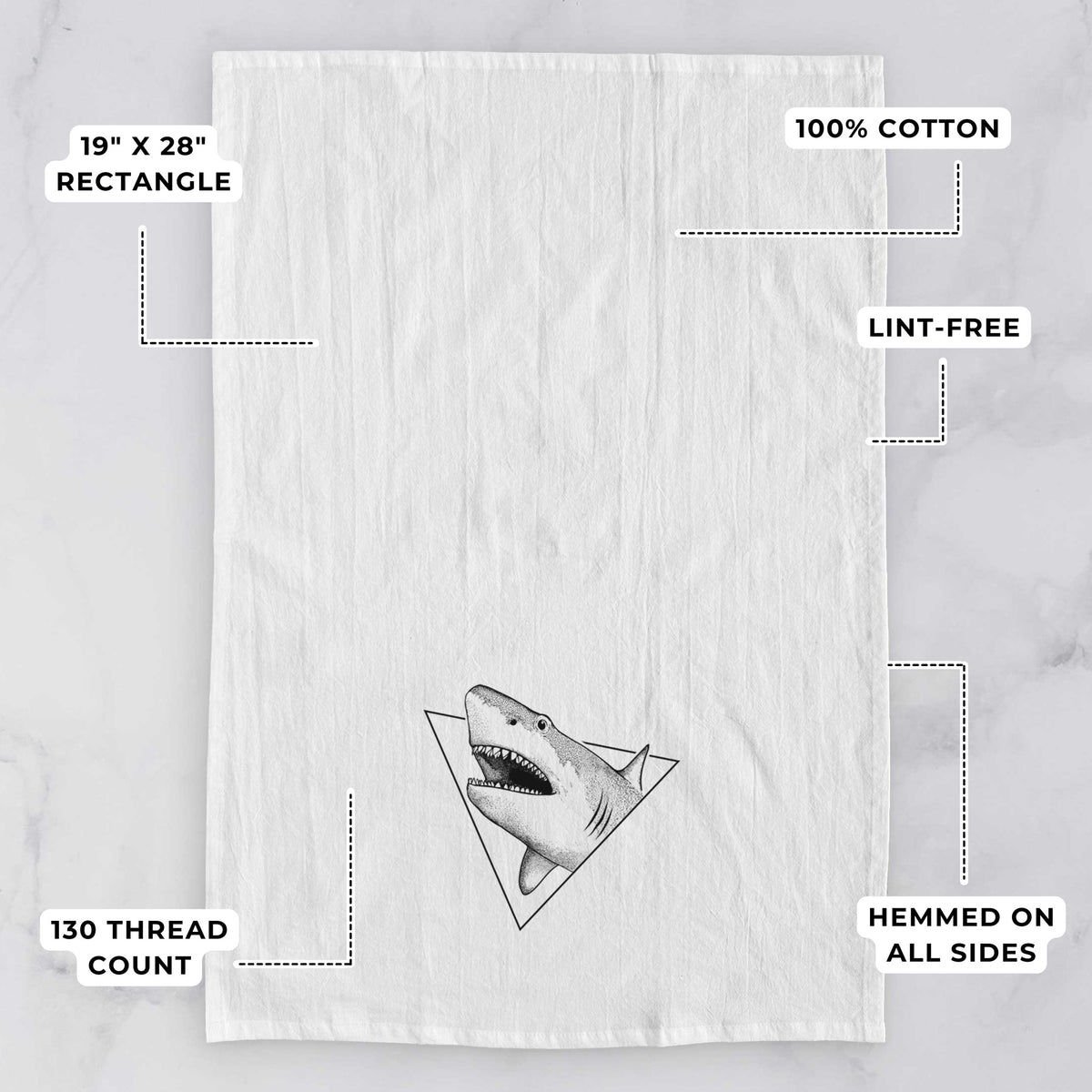 White tea towel printed with a black ink great white shark bursting out of a triangle outline with its mouth open, with feature labels: 19 by 28 inch rectangle, 100% cotton, lint-free, 130 thread count, hemmed on all sides.
