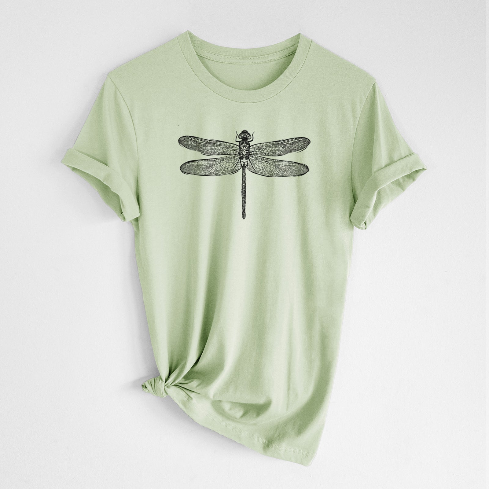Spring green lightweight cotton t-shirt laid flat with the sleeves rolled, printed with a detailed black ink illustration of a green darner dragonfly with its wings spread, seen from above.