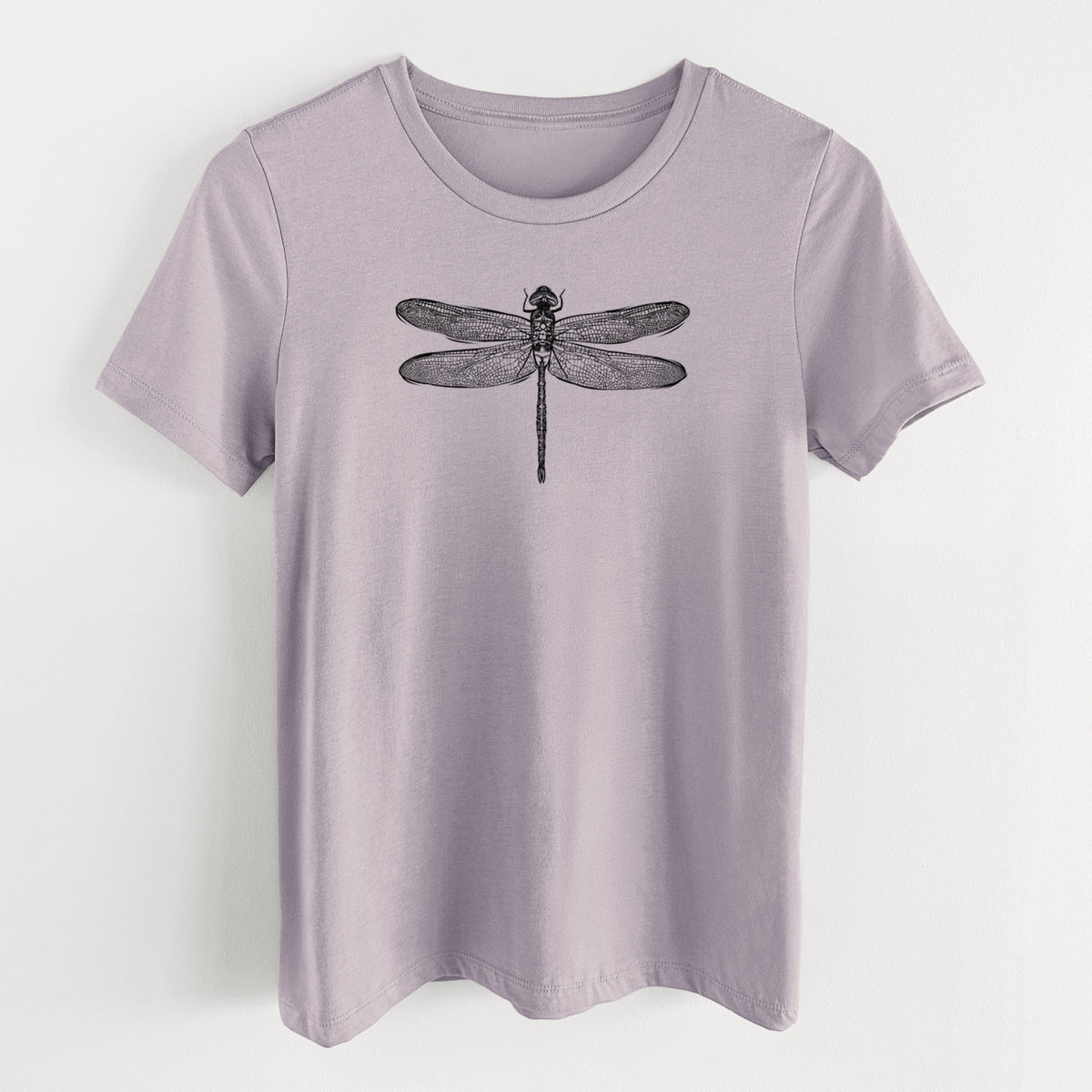 Light violet women's relaxed fit cotton t-shirt laid flat, printed with a detailed black ink illustration of a green darner dragonfly with its wings spread, seen from above.