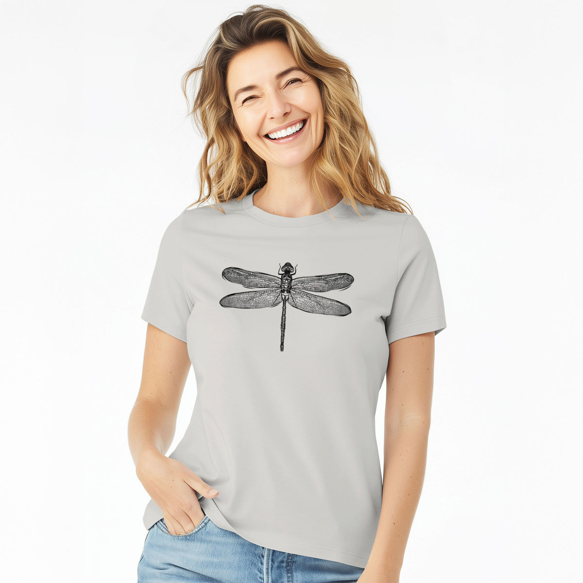Woman wearing a lunar grey women's relaxed fit cotton t-shirt printed with a detailed black ink illustration of a green darner dragonfly with its wings spread, seen from above.