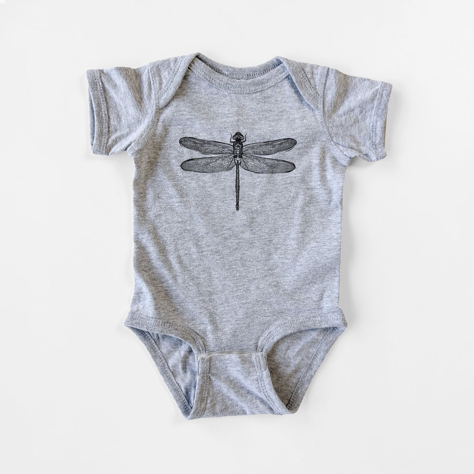 Grey baby bodysuit laid flat, printed with a detailed black ink illustration of a green darner dragonfly with its wings spread, seen from above.