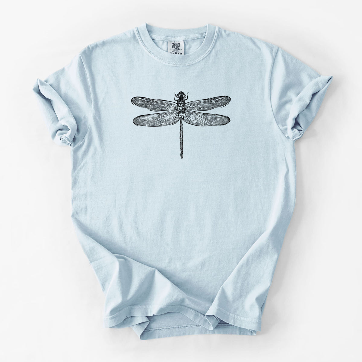 Chambray blue Comfort Colors t-shirt laid flat, printed with a detailed black ink illustration of a green darner dragonfly with its wings spread, seen from above.