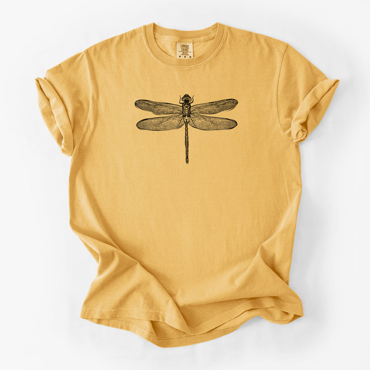 Golden wheat yellow Comfort Colors t-shirt laid flat, printed with a detailed black ink illustration of a green darner dragonfly with its wings spread, seen from above.