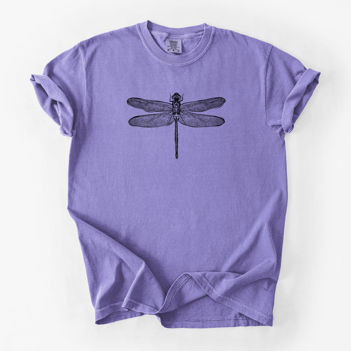 Violet purple Comfort Colors t-shirt laid flat, printed with a detailed black ink illustration of a green darner dragonfly with its wings spread, seen from above.