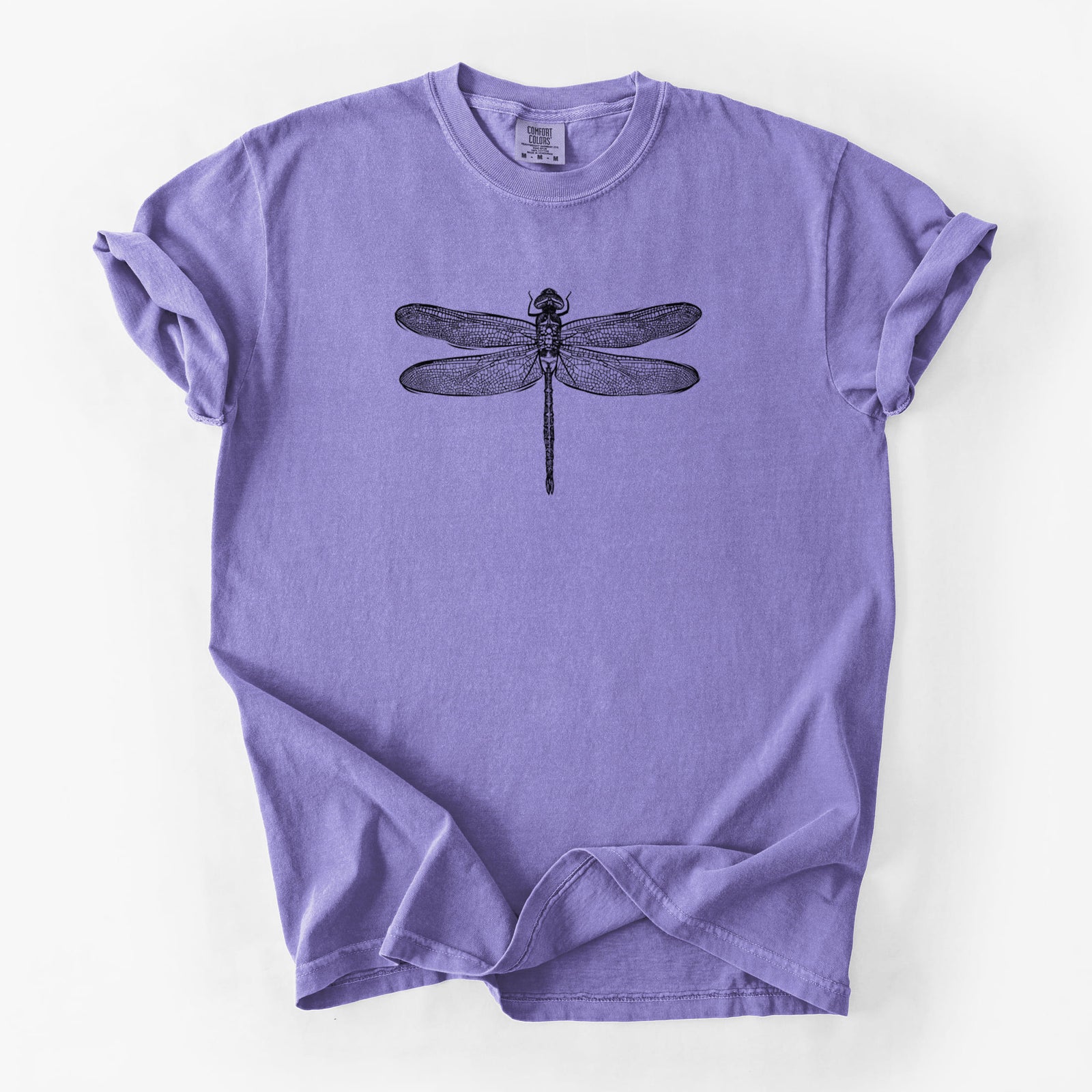 Blue jean Comfort Colors t-shirt laid flat, printed with a detailed black ink illustration of a green darner dragonfly with its wings spread, seen from above.