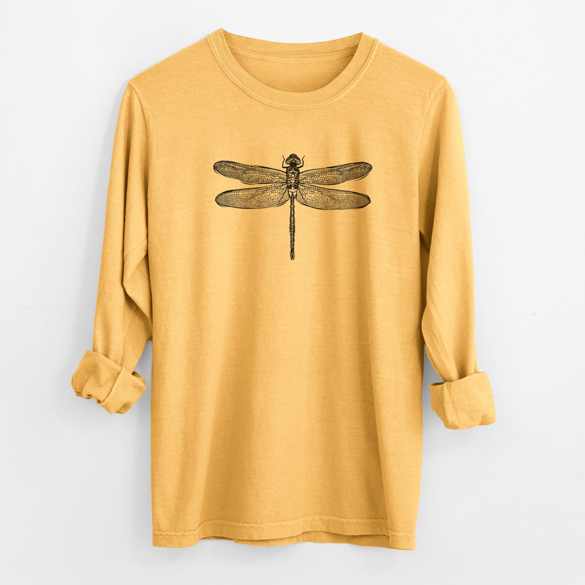 Golden wheat yellow Comfort Colors long sleeve shirt laid flat with the cuffs rolled, printed with a detailed black ink illustration of a green darner dragonfly with its wings spread, seen from above.