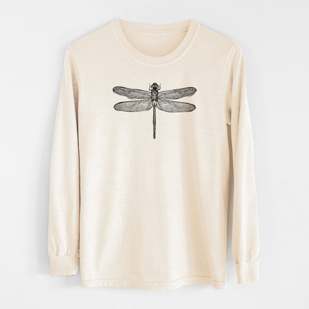 Ivory Comfort Colors long sleeve shirt laid flat, printed with a detailed black ink illustration of a green darner dragonfly with its wings spread, seen from above.