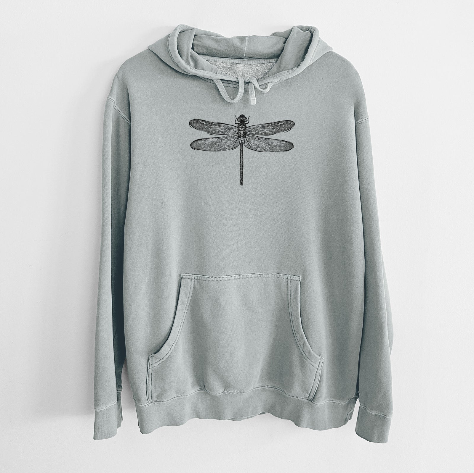 Sage green pigment dyed hoodie laid flat, printed with a detailed black ink illustration of a green darner dragonfly with its wings spread, seen from above.