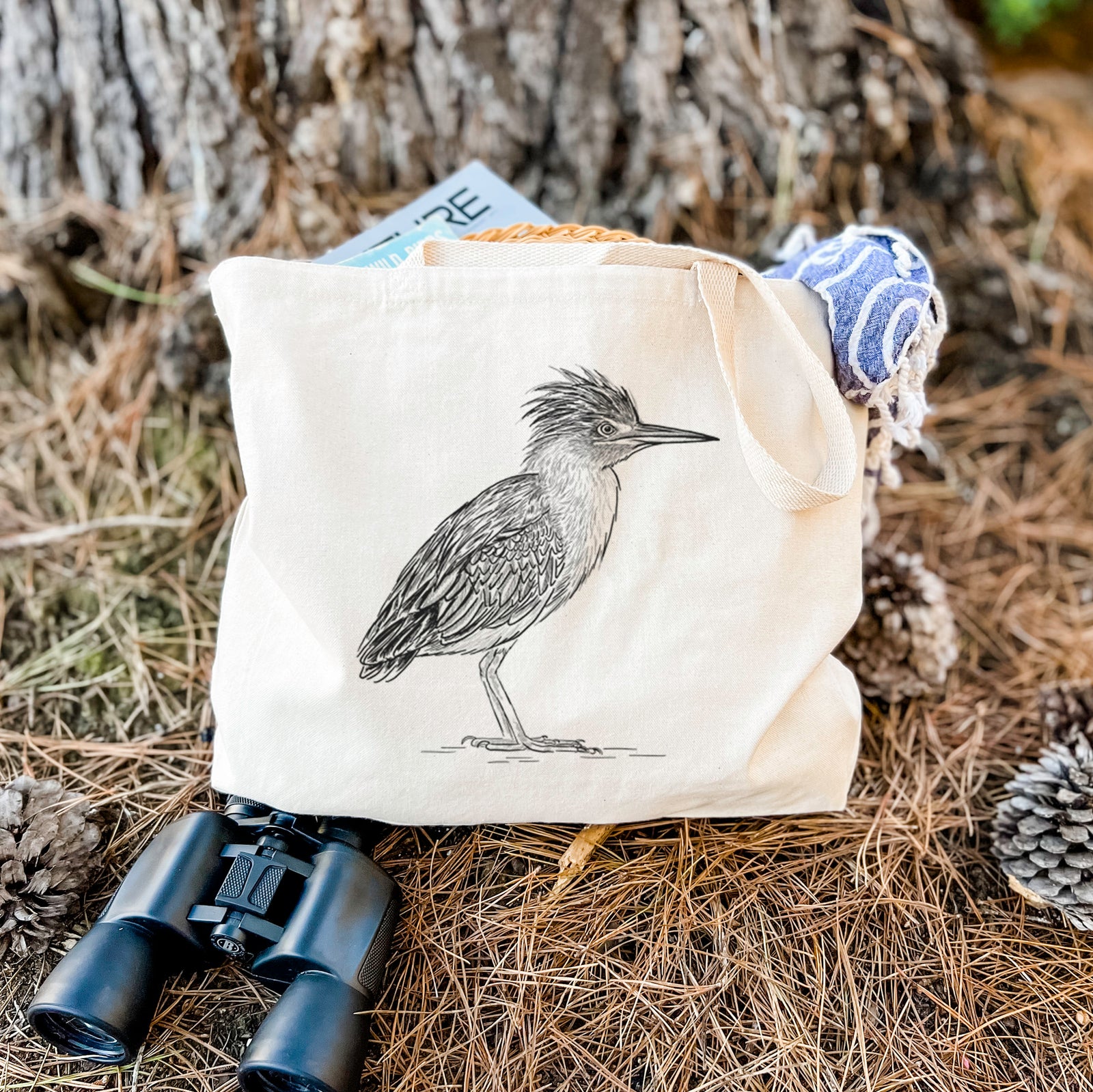 Natural canvas tote bag printed with a detailed black ink illustration of a green heron standing with its crest raised.