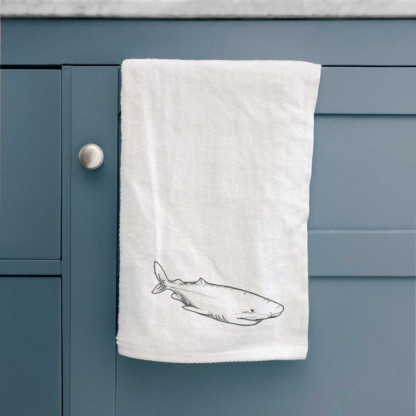 White hand towel printed with a black ink illustration of a Greenland shark swimming.