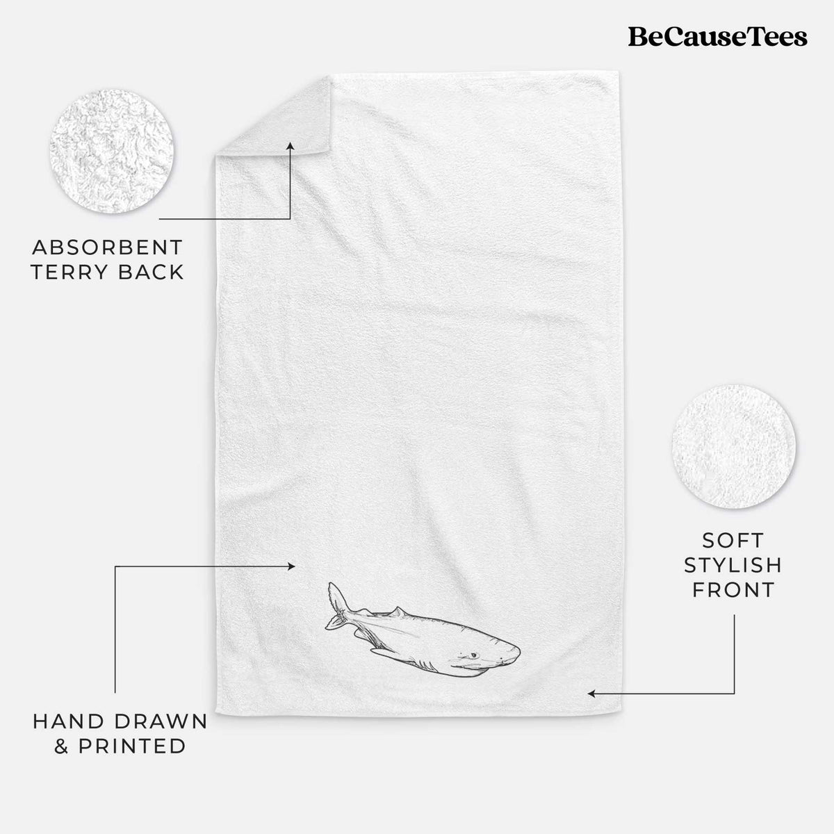 White hand towel printed with a black ink illustration of a Greenland shark swimming.