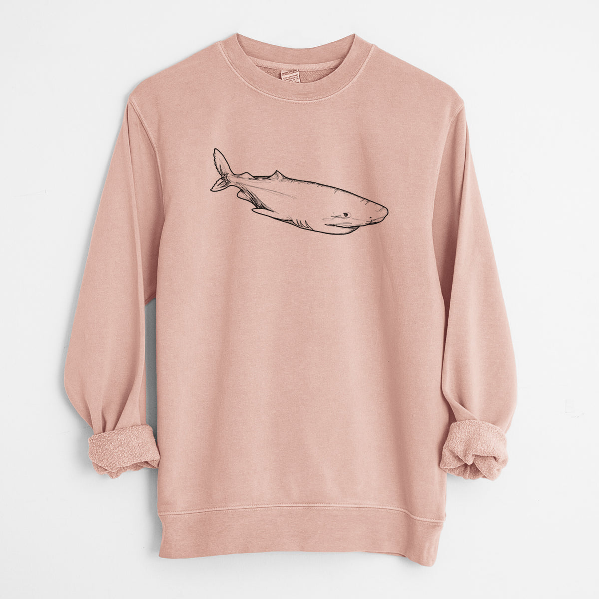 Dusty pink pigment dyed crewneck sweatshirt laid flat with the sleeves rolled, printed with a black ink illustration of a Greenland shark swimming.