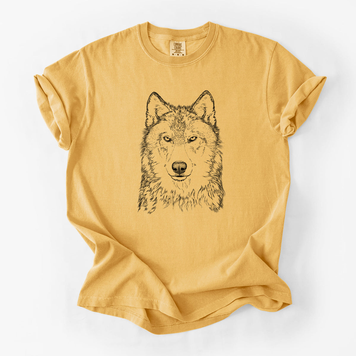 Golden wheat yellow Comfort Colors t-shirt laid flat, printed with a detailed black ink portrait of a grey wolf facing forward.