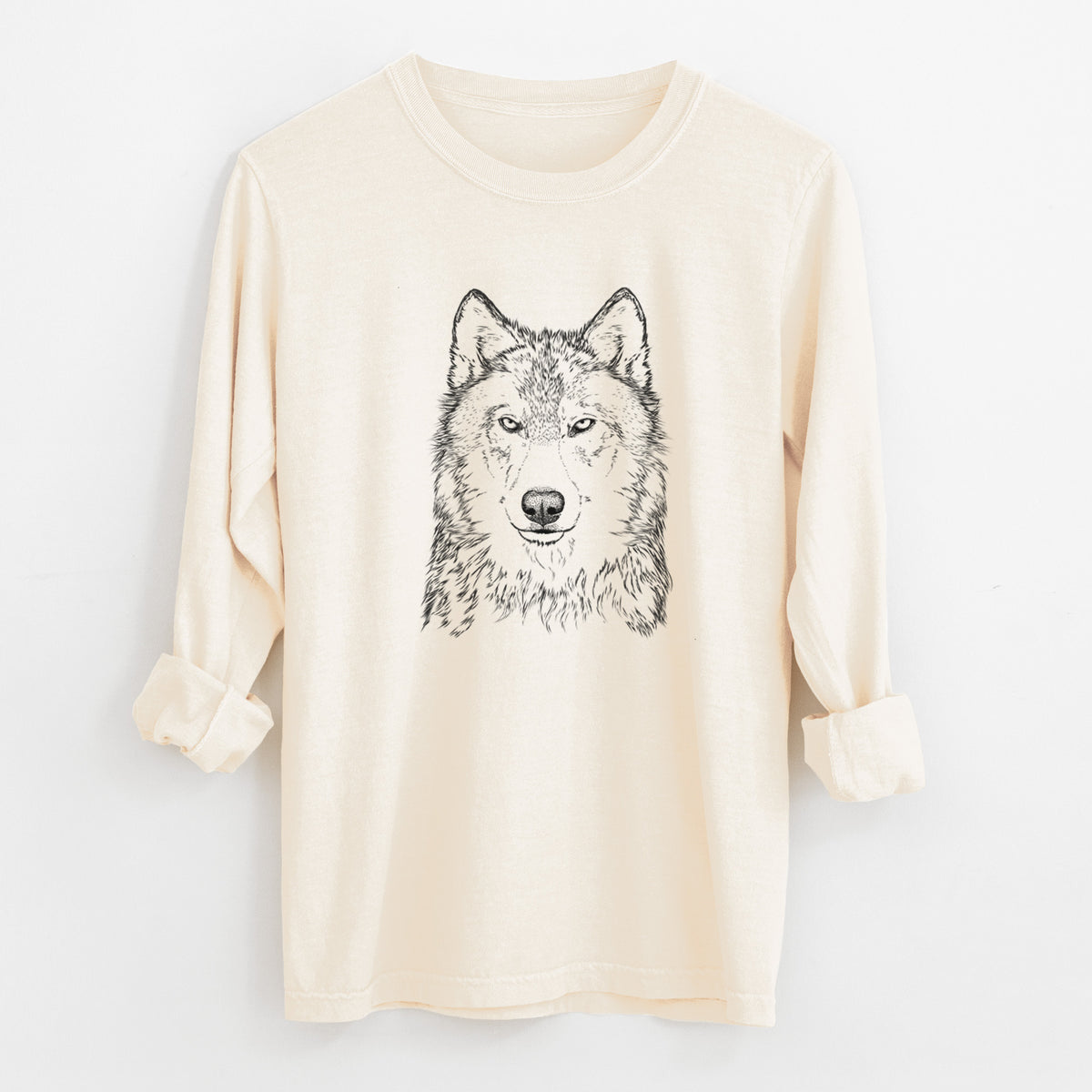 Ivory Comfort Colors long sleeve shirt laid flat with the cuffs rolled, printed with a detailed black ink portrait of a grey wolf facing forward.