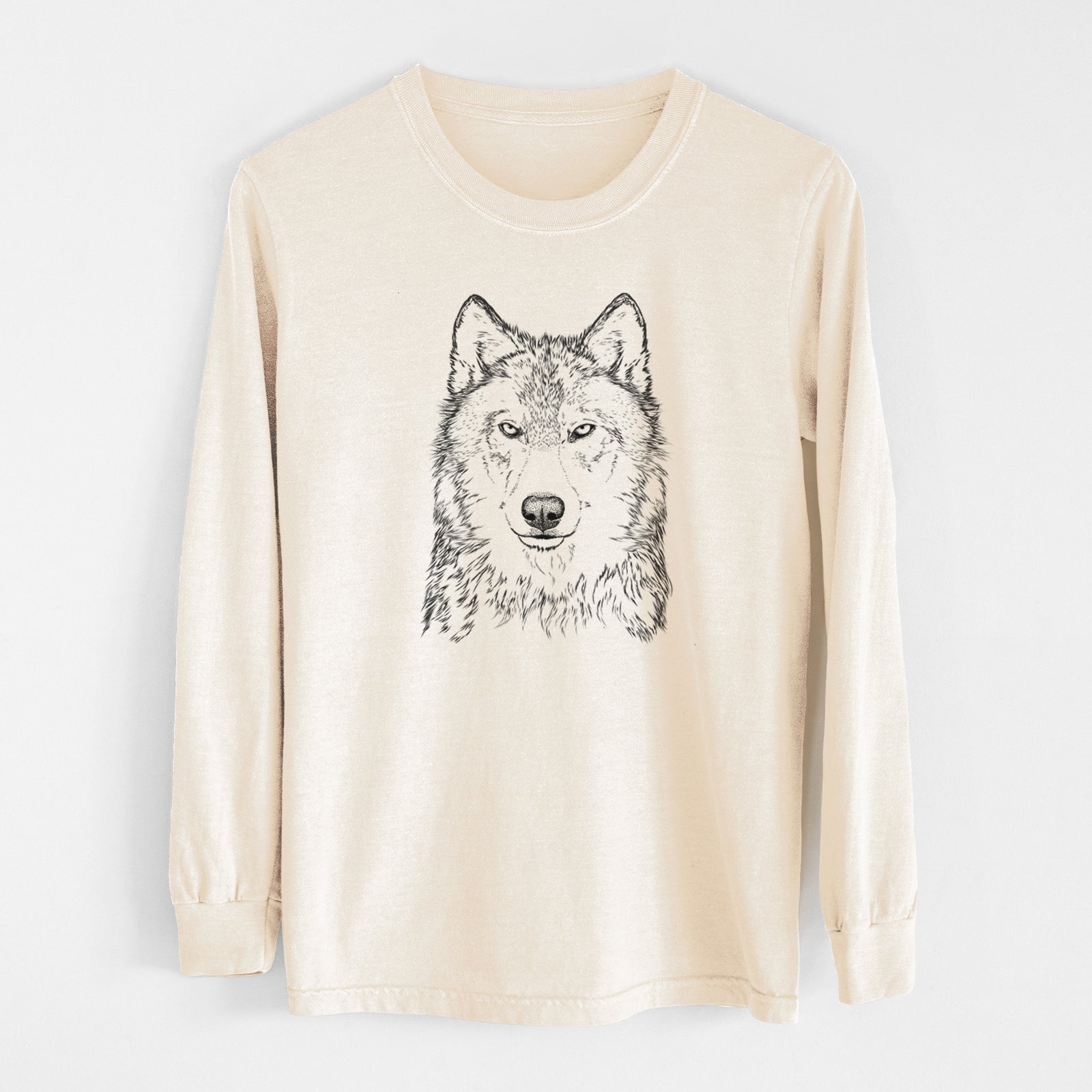 Ivory Comfort Colors long sleeve shirt laid flat, printed with a detailed black ink portrait of a grey wolf facing forward.