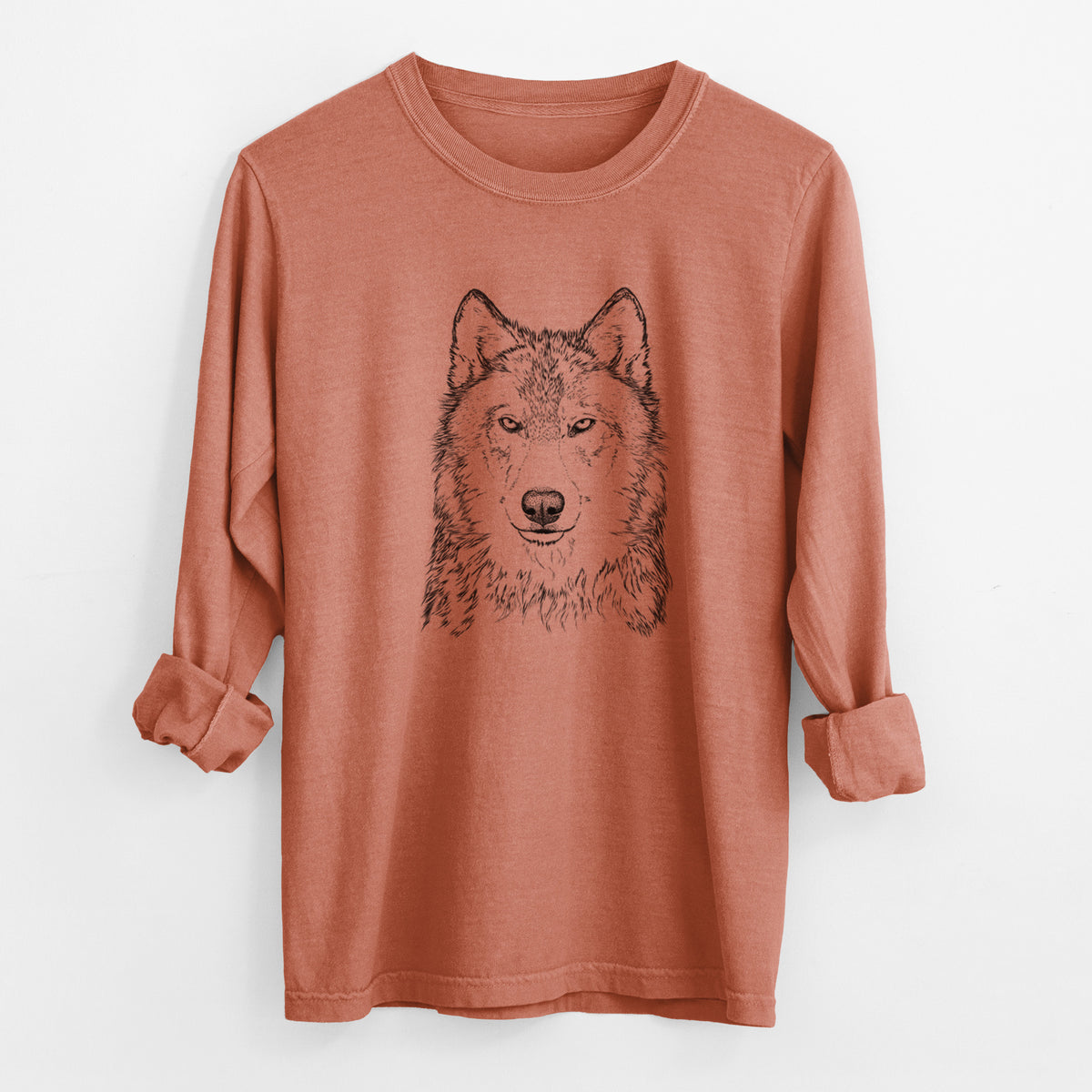Yam burnt orange Comfort Colors long sleeve shirt laid flat with the cuffs rolled, printed with a detailed black ink portrait of a grey wolf facing forward.