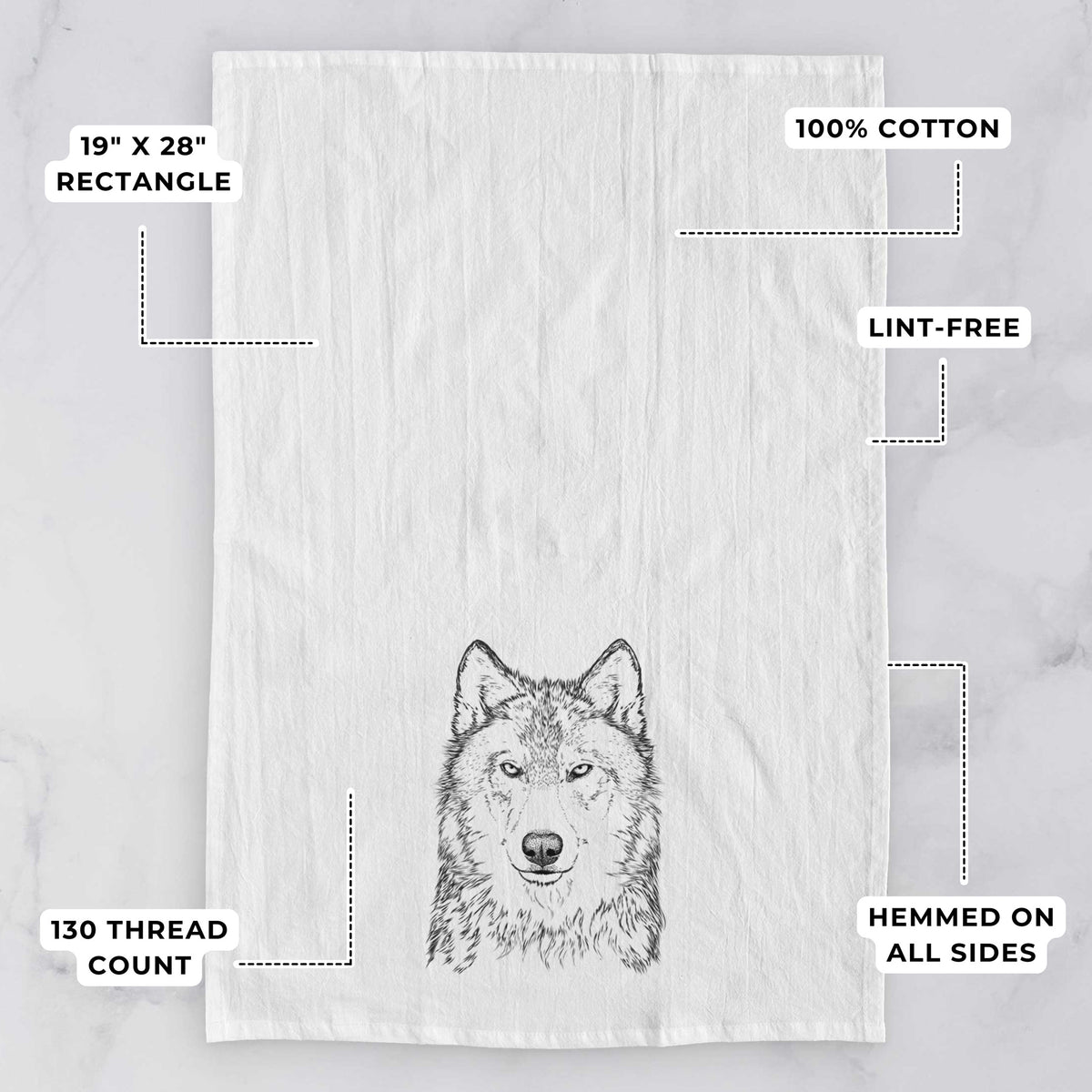 White tea towel printed with a detailed black ink portrait of a grey wolf facing forward, with feature labels: 19 by 28 inch rectangle, 100% cotton, lint-free, 130 thread count, hemmed on all sides.