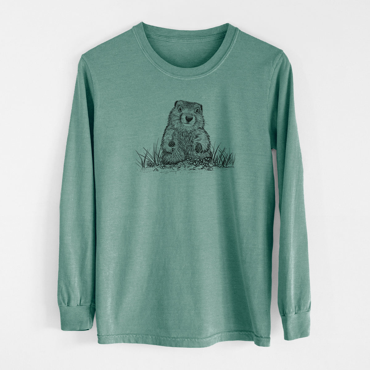 Pine green Comfort Colors long sleeve shirt laid flat, printed with a black ink illustration of a groundhog peeking out of its burrow among grass.