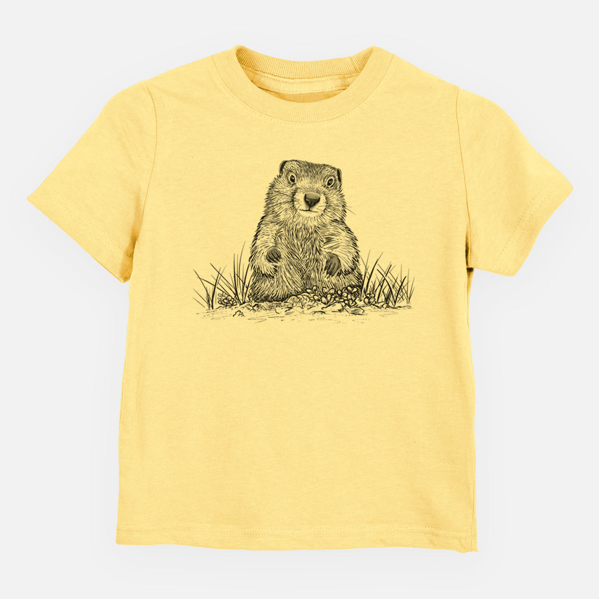 Butter yellow toddler t-shirt laid flat, printed with a black ink illustration of a groundhog peeking out of its burrow among grass.