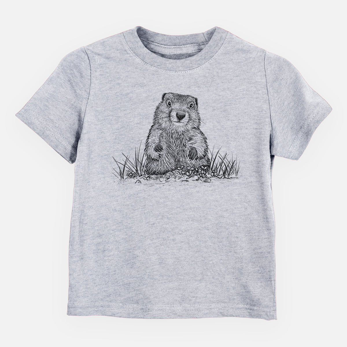 Heather grey toddler t-shirt laid flat, printed with a black ink illustration of a groundhog peeking out of its burrow among grass.