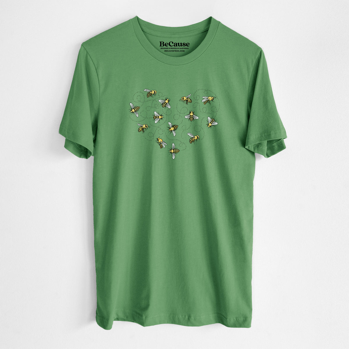 Leaf green lightweight cotton t-shirt laid flat, printed with a heart shape made of small bees and looping flight trails.