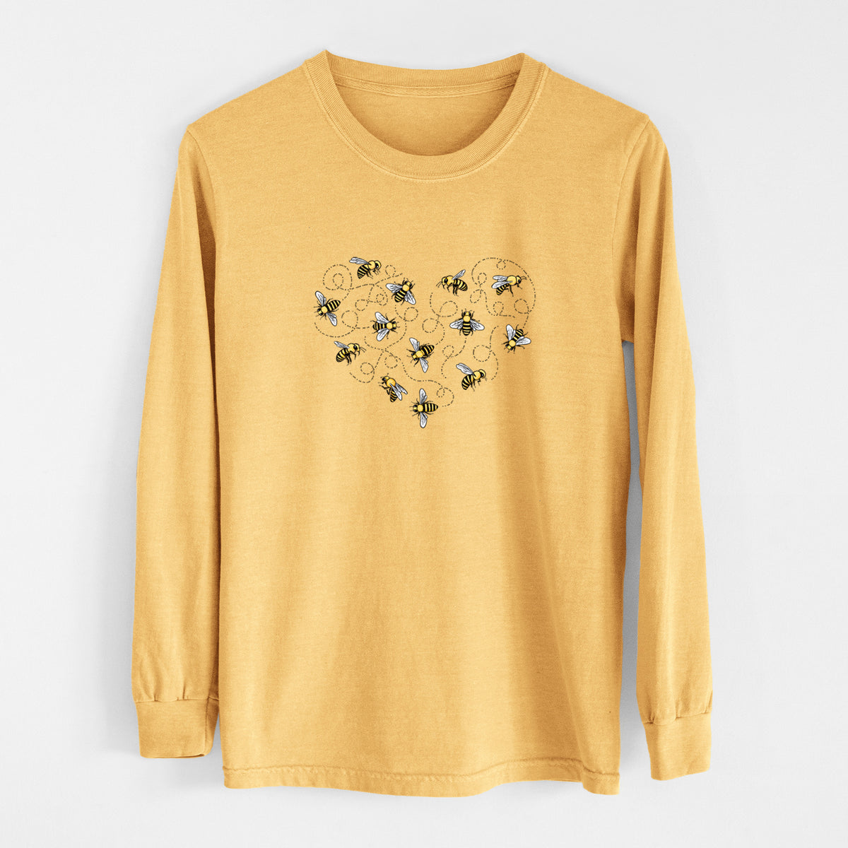 Golden wheat yellow Comfort Colors long sleeve shirt laid flat, printed with a heart shape made of small bees and looping flight trails.