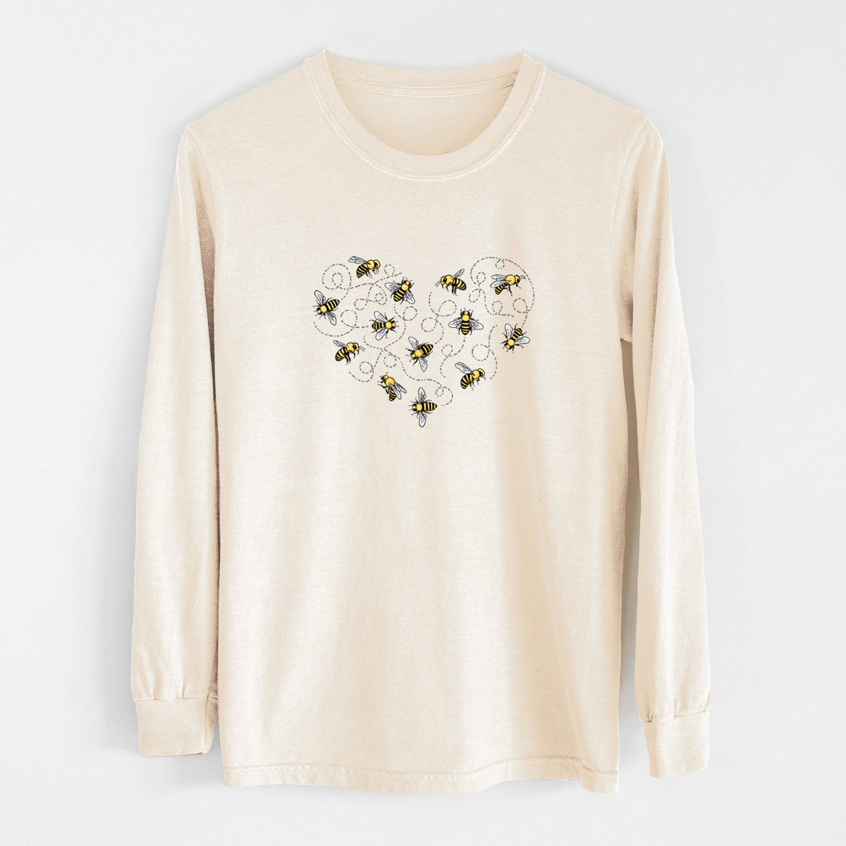 Ivory Comfort Colors long sleeve shirt laid flat, printed with a heart shape made of small bees and looping flight trails.