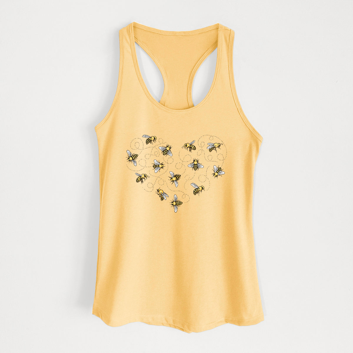 Banana cream women's racerback tank top laid flat, printed with a heart shape made of small bees and looping flight trails.