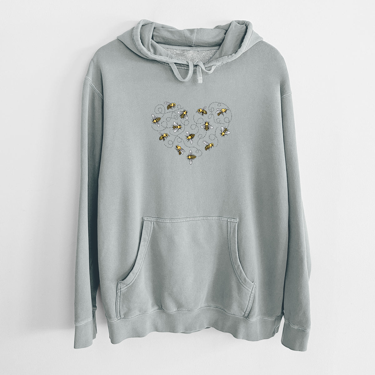Sage green pigment dyed hoodie laid flat, printed with a heart shape made of small bees and looping flight trails.