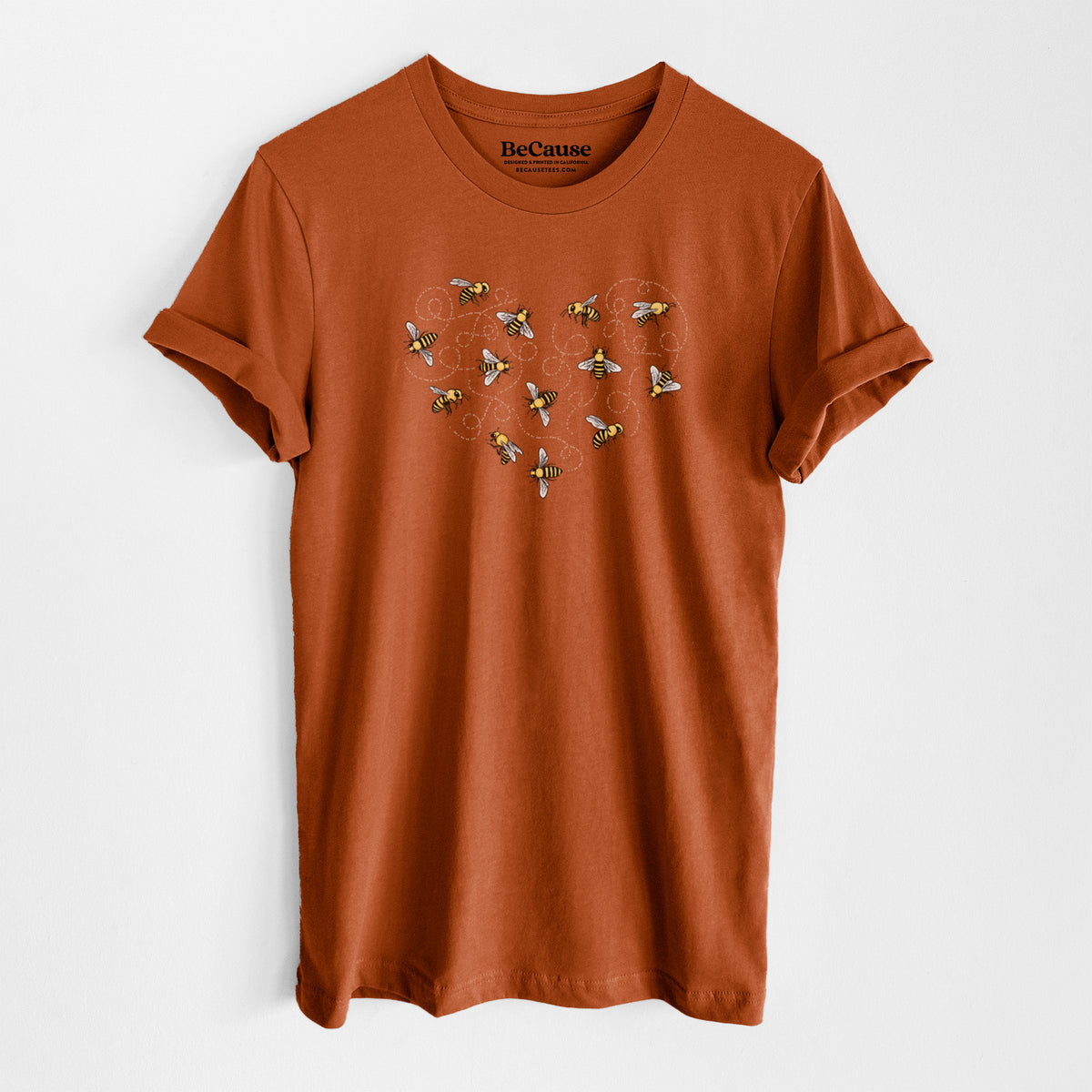 Autumn lightweight cotton t-shirt laid flat, printed with a heart shape made of small bees and looping flight trails.