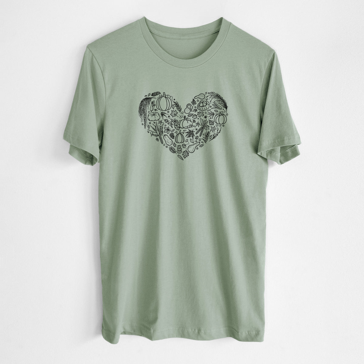 Sage green lightweight cotton t-shirt laid flat, printed with a heart shape filled with black ink autumn leaves, acorns, pumpkins and mushrooms.