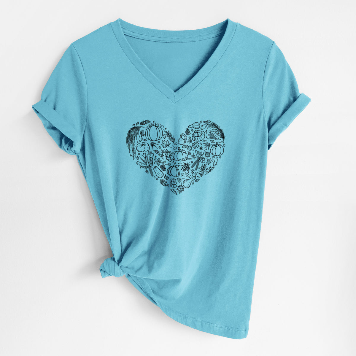 Turquoise women's relaxed fit cotton V-neck t-shirt laid flat, printed with a heart shape filled with black ink autumn leaves, acorns, pumpkins and mushrooms.