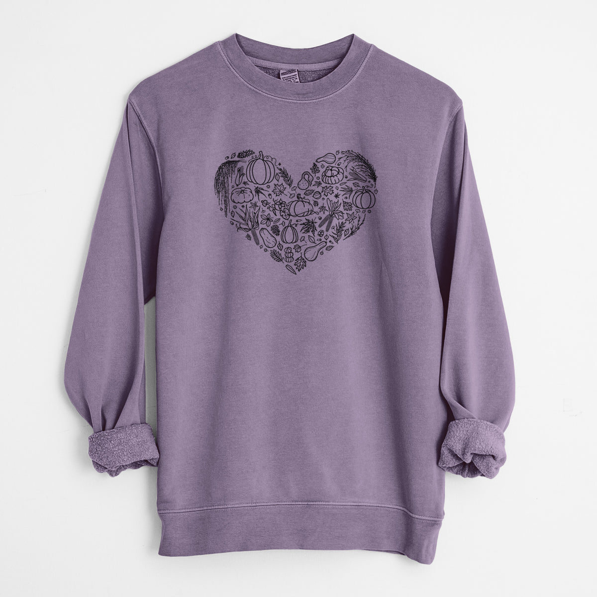 Plum purple pigment dyed crewneck sweatshirt laid flat with the sleeves rolled, printed with a heart shape filled with black ink autumn leaves, acorns, pumpkins and mushrooms.