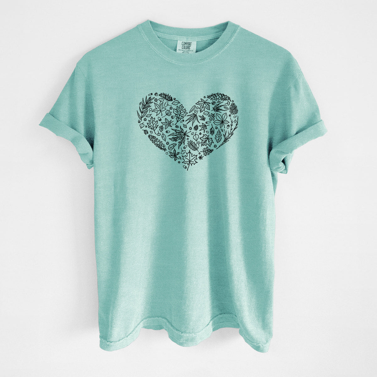 Chalky mint Comfort Colors t-shirt laid flat, printed with a heart shape filled with black ink autumn leaves.