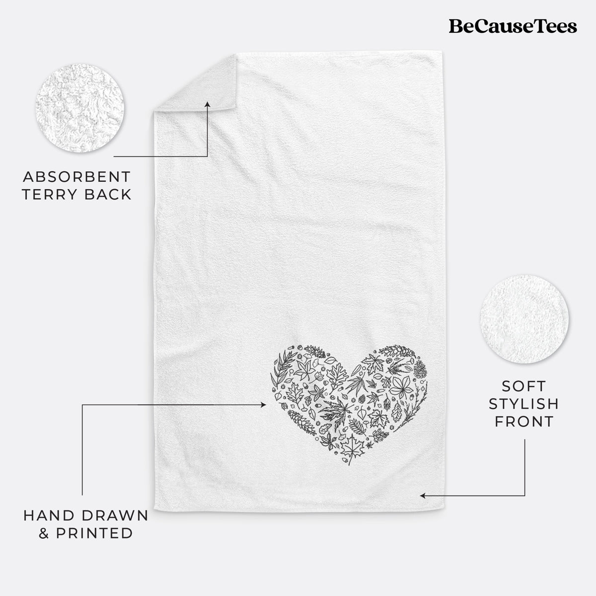 White hand towel printed with a heart shape filled with black ink autumn leaves.