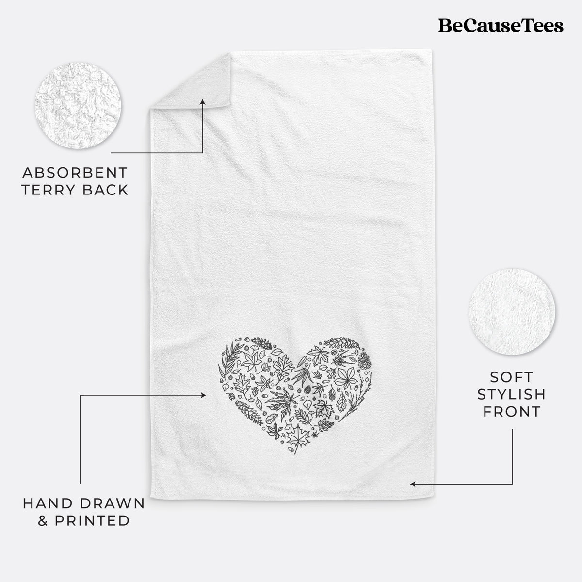 White hand towel printed with a heart shape filled with black ink autumn leaves.