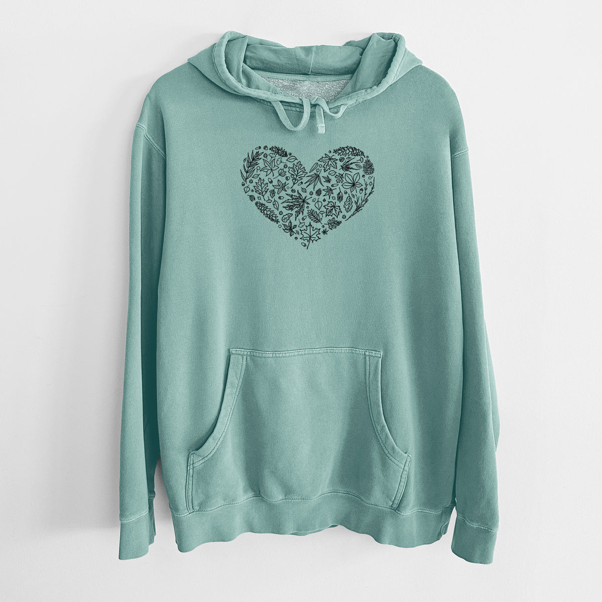 Mint green pigment dyed hoodie laid flat, printed with a heart shape filled with black ink autumn leaves.