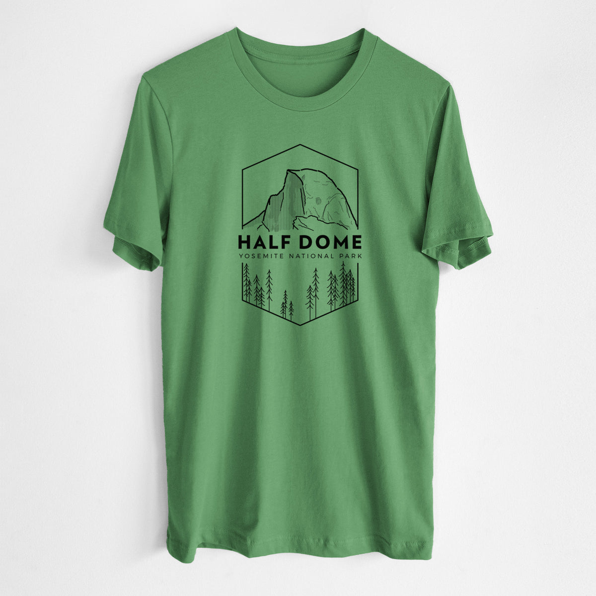 Leaf green lightweight cotton t-shirt laid flat, printed with a black line art badge of Half Dome above a pine forest, with the words Half Dome, Yosemite National Park.