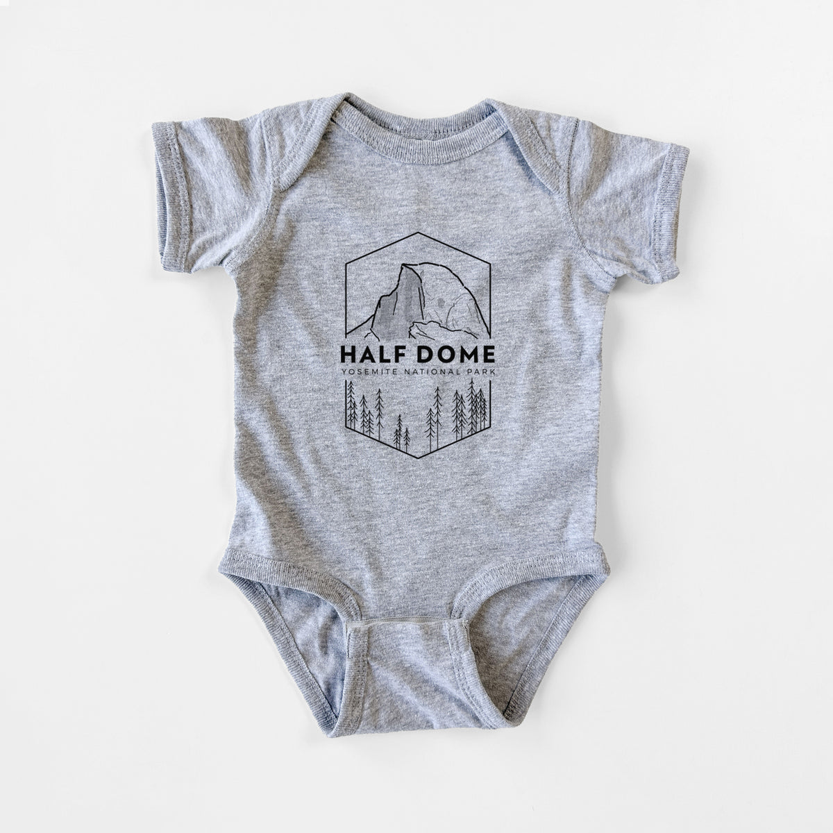 Grey baby bodysuit laid flat, printed with a black line art badge of Half Dome above a pine forest, with the words Half Dome, Yosemite National Park.
