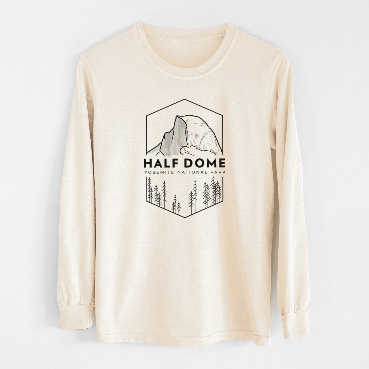 Ivory Comfort Colors long sleeve shirt laid flat, printed with a black line art badge of Half Dome above a pine forest, with the words Half Dome, Yosemite National Park.