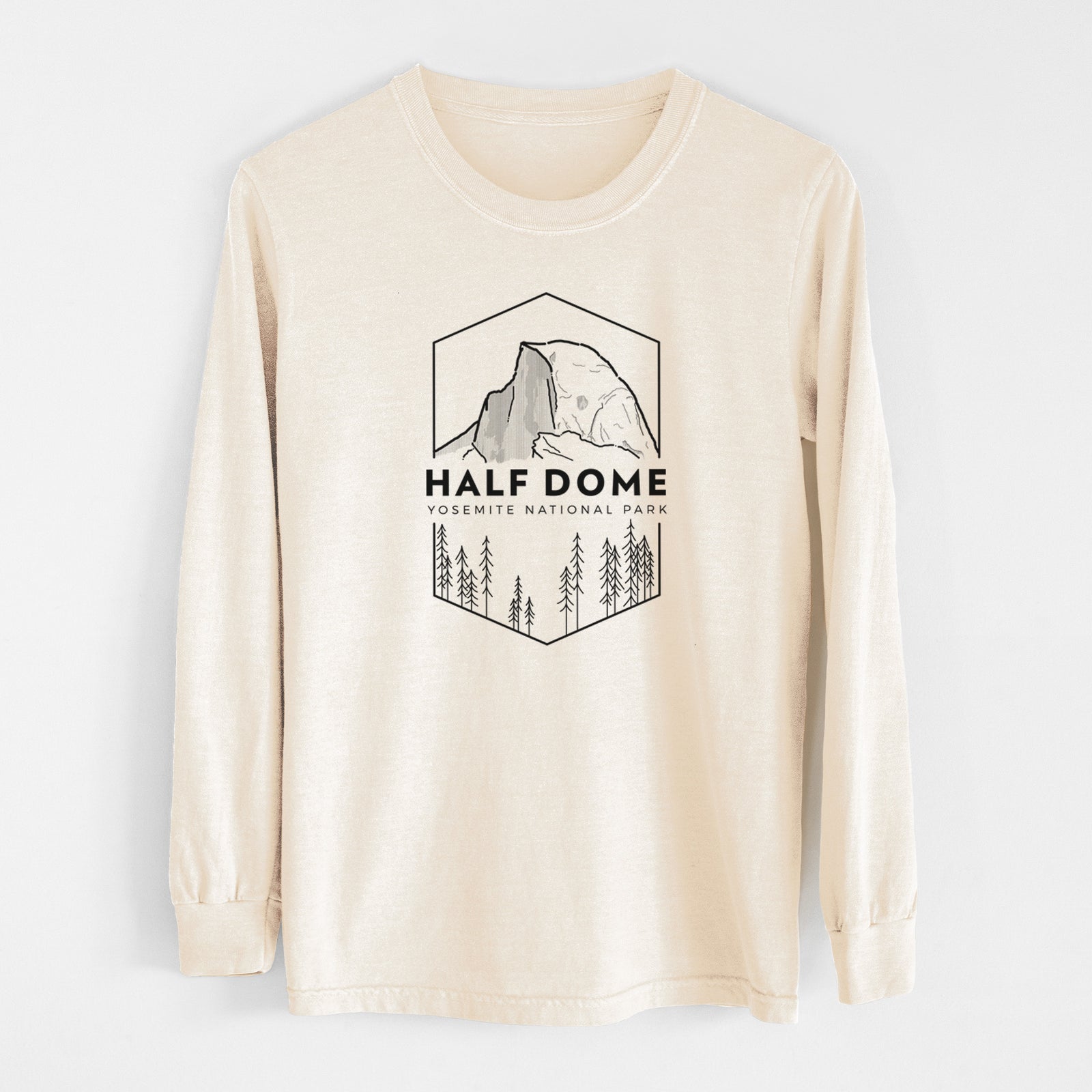 Ivory Comfort Colors long sleeve shirt laid flat, printed with a black line art badge of Half Dome above a pine forest, with the words Half Dome, Yosemite National Park.