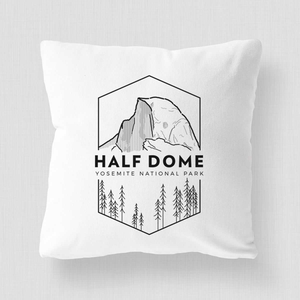 White pillow cover printed with a black line art badge of Half Dome above a pine forest, with the words Half Dome, Yosemite National Park.