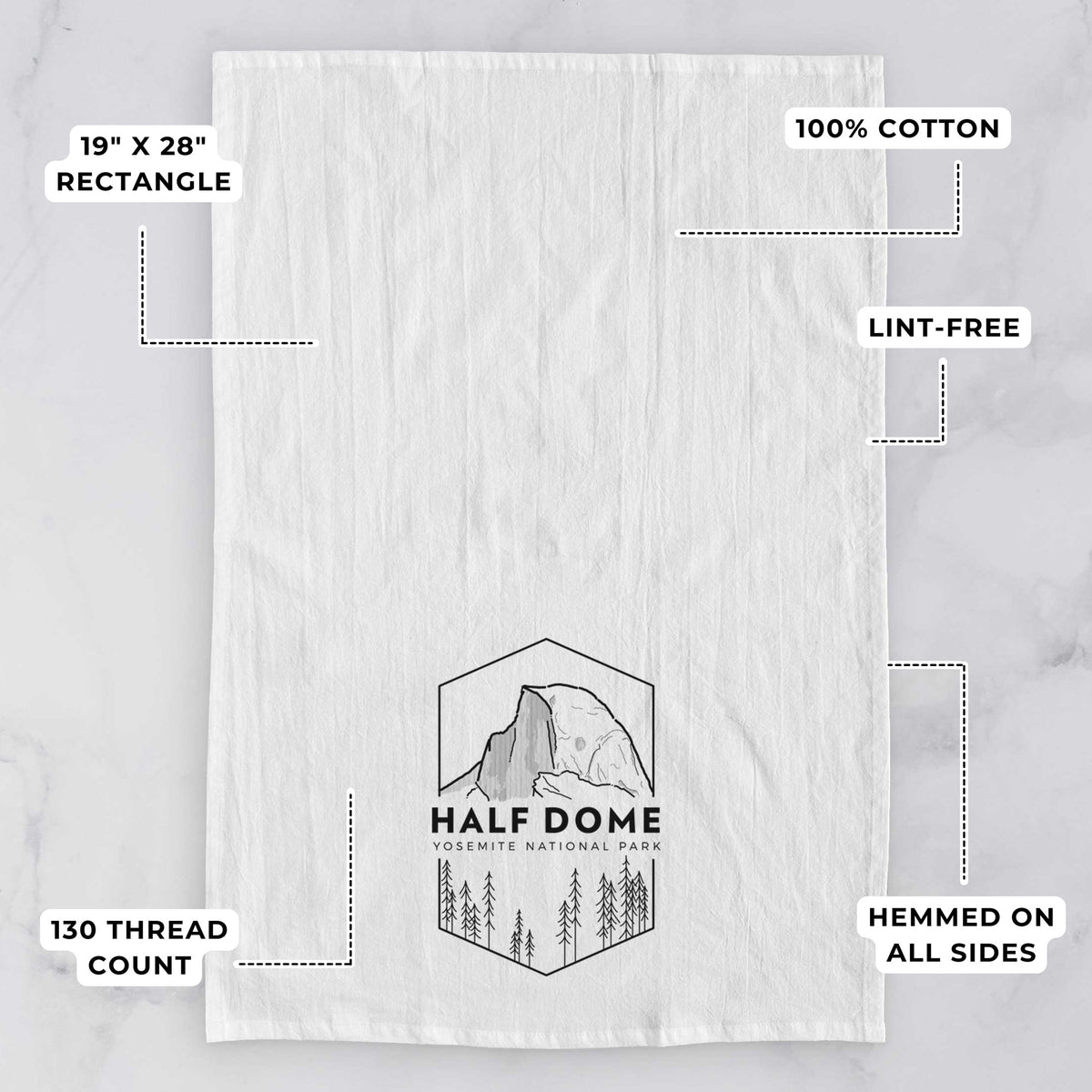 White tea towel printed with a black line art badge of Half Dome above a pine forest, with the words Half Dome, Yosemite National Park, with feature labels: 19 by 28 inch rectangle, 100% cotton, lint-free, 130 thread count, hemmed on all sides.