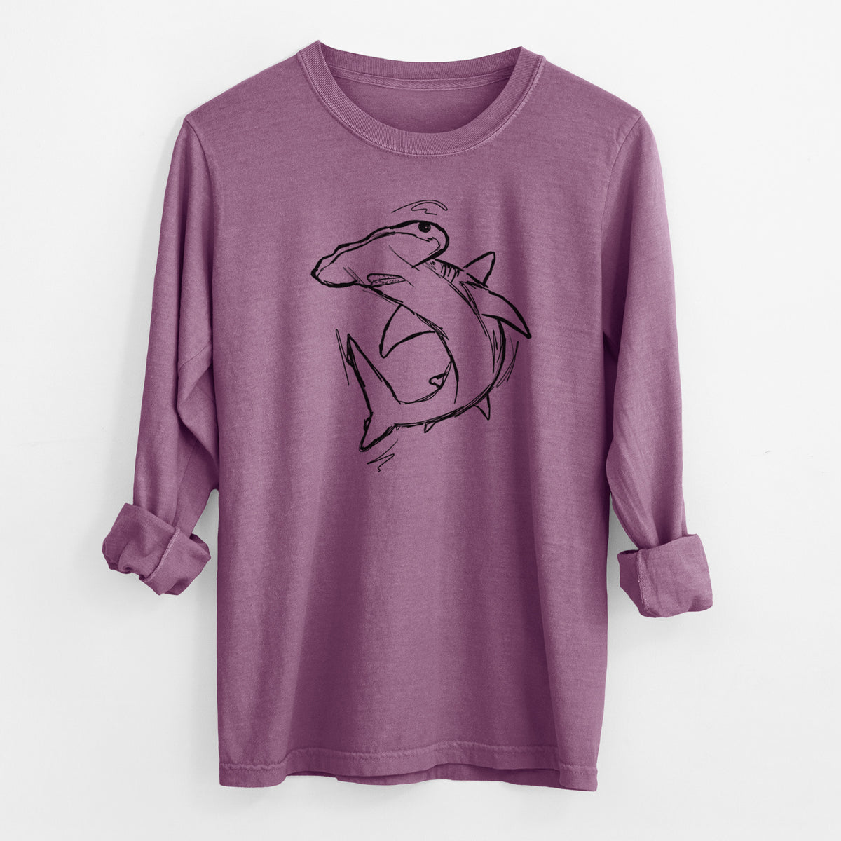 Berry pink Comfort Colors long sleeve shirt laid flat with the cuffs rolled, printed with a black ink illustration of a hammerhead shark swimming in a curve.
