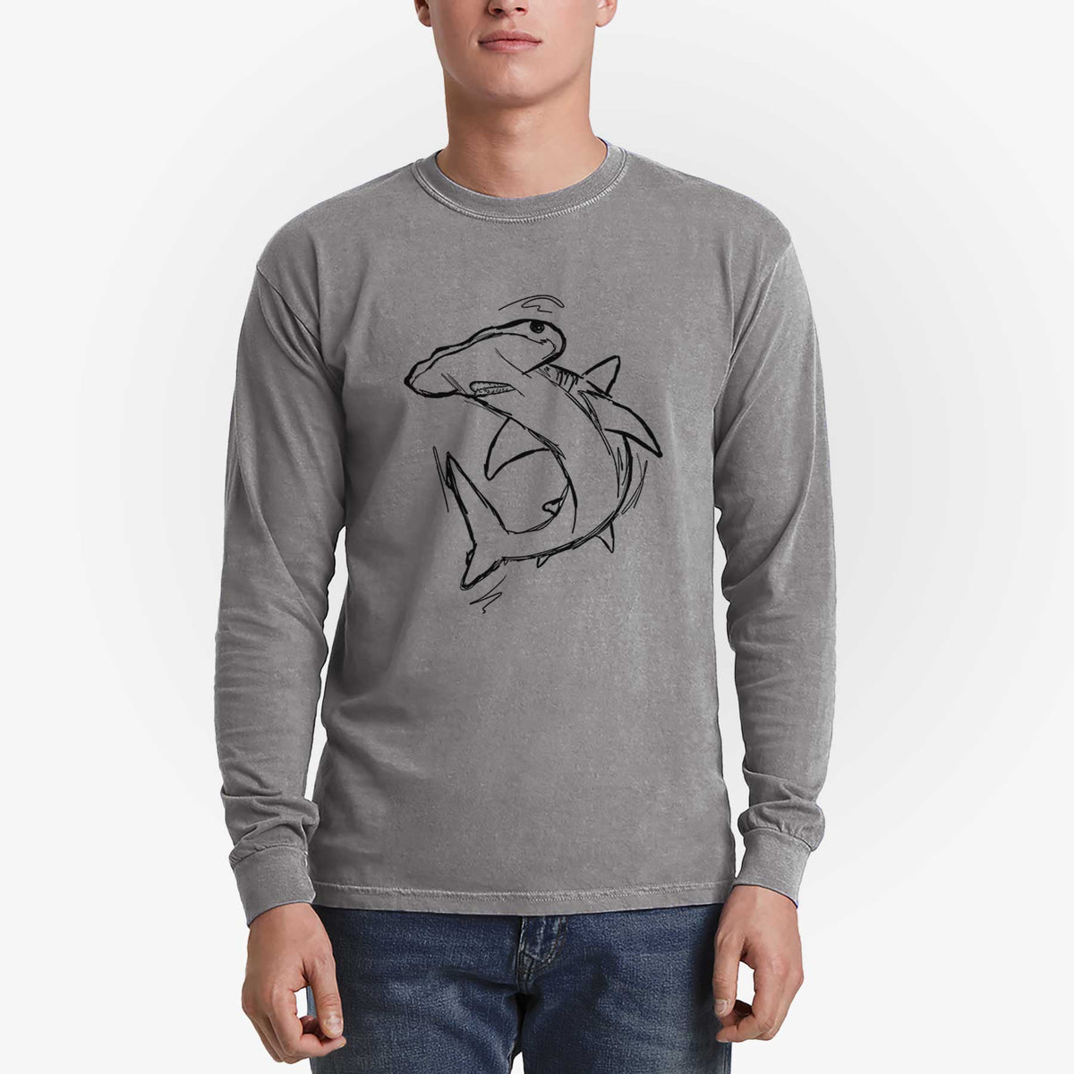 Man wearing a grey Comfort Colors long sleeve shirt printed with a black ink illustration of a hammerhead shark swimming in a curve.